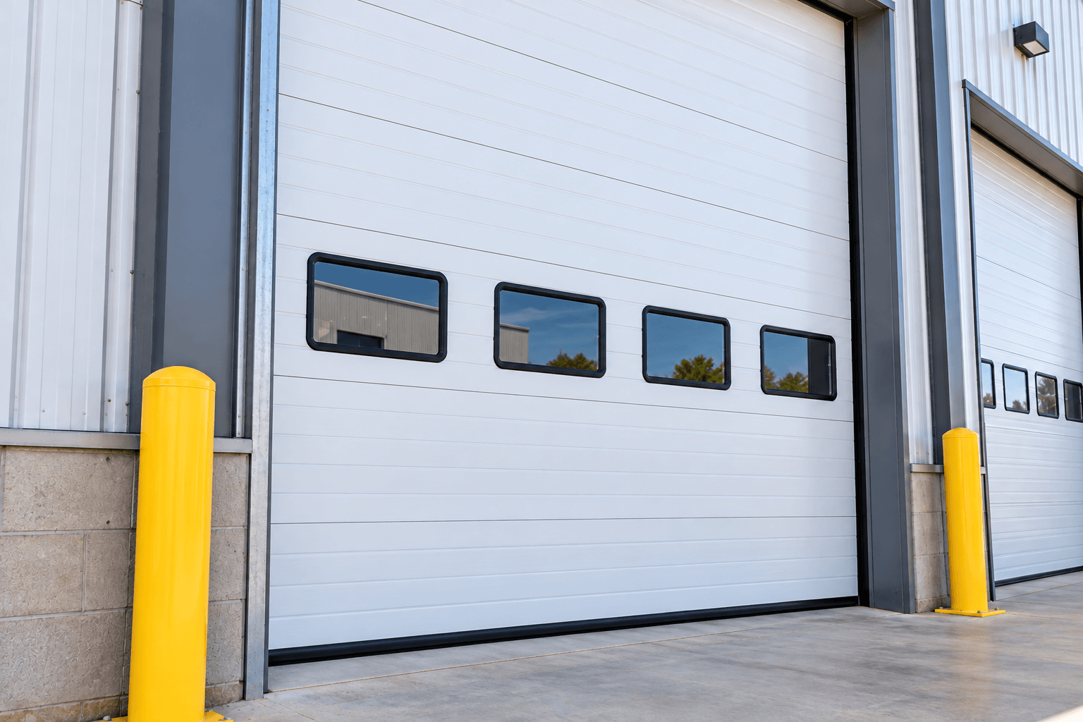 Commercial garage door fully restored after repair at a business property in Porter TX