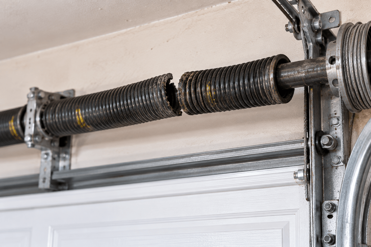 Damaged garage door before spring repair service in Porter TX
